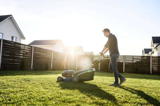 A man mowing the lawn with push lawn mower