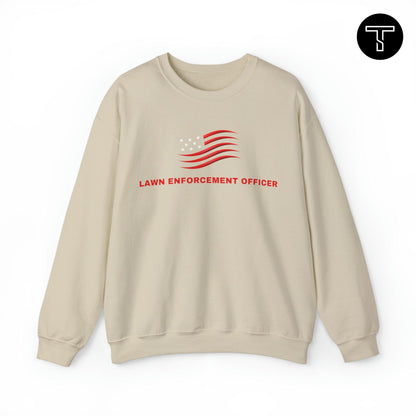 A beige sweatshirt with phrase "lawn enforcement officer" and an symbol of the American flag